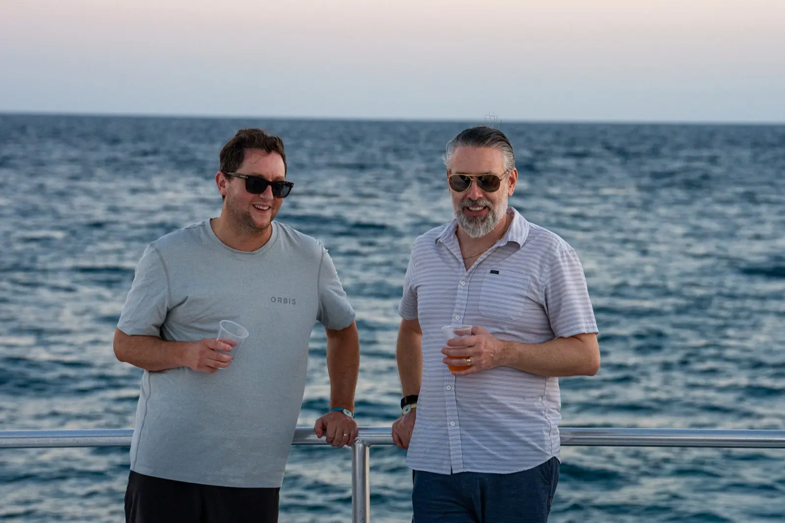 Two brokers on the catamaran at sunset